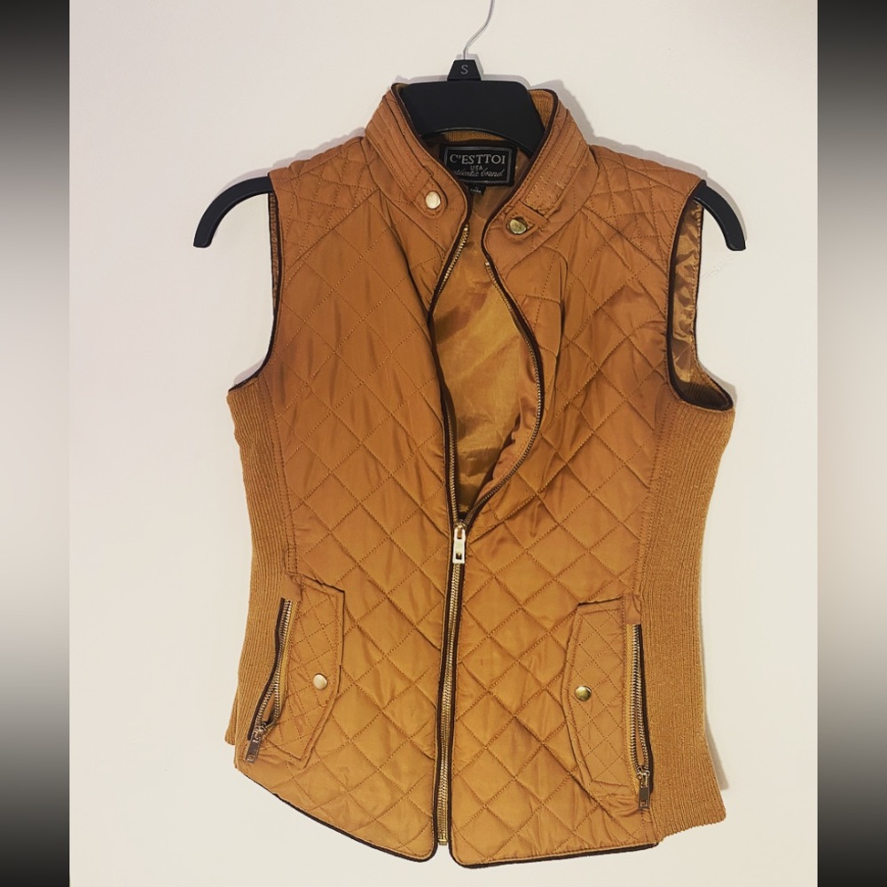 Small fitted vest, all zippers are functioning.